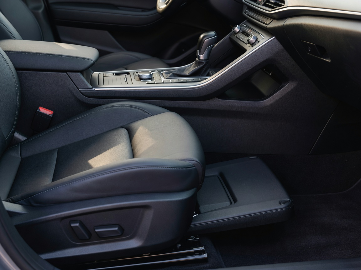 Car centre console and front-seat area illustrating the need to preserve controls and seat movement
